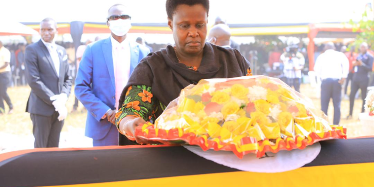 Vice President Jessica Alupo lays a wreath on the casket of Cecilia Ogwal.