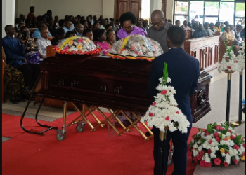 Ex-PM Rugunda lays wreath on the casket containing remains on Kirasha yesterday at St Andrews Church, Bukoto.