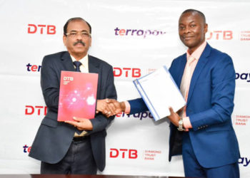 Varghese Thambi, Managing Director, Diamond Trust Bank and TerraPay’s Muyingo after signing the deal