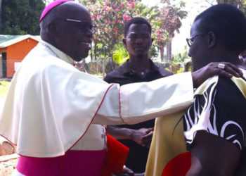 Archbishop Emeritus John Baptist Odama consoles a christian shortly after announcing his retirement on March 22 2024 at St Joseph’s Cathedral in Gulu City. PHOTO URN