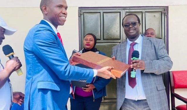 Kabale High Court Resident Judge (Right) at the Launch of Small Claims Procedure-SCP in Kyanika as the Registrar in charge of SCP Mastulah Mulondo looks on from behind. PHOTO URN.