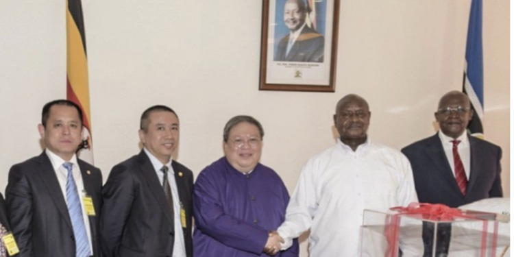 USA Exhibits: Museveni, Sam Kutesa shaking hands with Chinese convicts of Bribery - Image may be subject to copyright