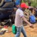 People siphoning fuel from a truck involved in an accident. Image maybe subject to copyright.