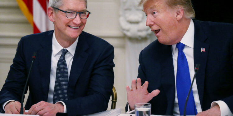 Apple CEO Tim Cook laughs with President Donald Trump during a meeting in the White House, Washington, March 6, 2019.
Leah Millis | Reuters